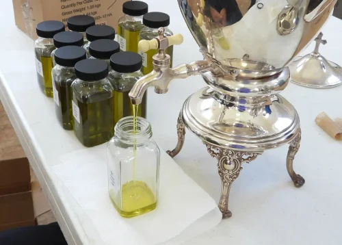 A bottle is filled with fresh chrism oils.