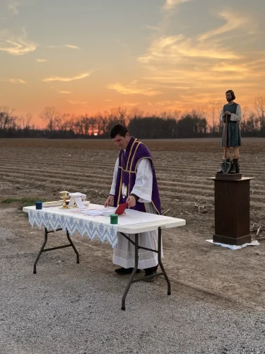 Fr. Taylor Reynolds blessing the fields on March 1.