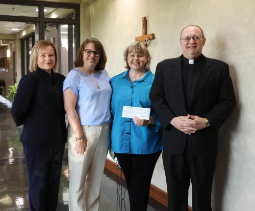 OUR LADY OF PROMPT SUCCOR SCHOOL. Pictured left to right: Becky Crooks, board member for the Catholic Foundation; Meredith Rhoads, OLPS principal; Sarah Kramer of Hope Farrar Kramer Education Trust; OLPS pastor, Fr. Rusty Rabalais.
