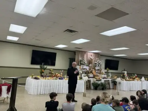 Pastor, Fr. Wade deCoste, blesses the St. Joseph Altar at St. Joseph Church, Marksville