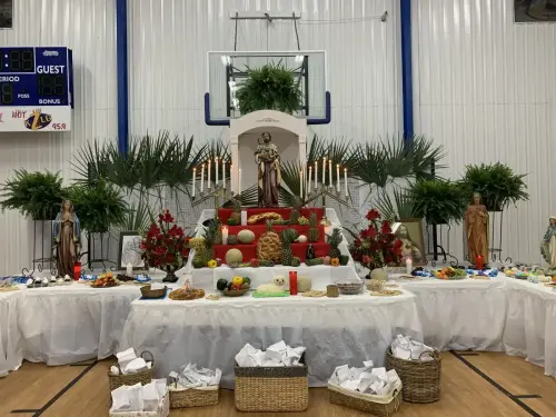 The simple sweets altar was adorned with St. Joseph and many religious statues and Holy pictures.Sweets, fruits, and vegetables were donated as prayer offerings on behalf of the families of Sacred Heart School.