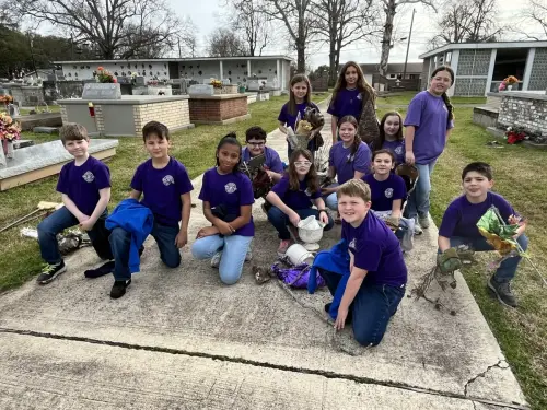 Sacred Heart School's 4th grade completed a Season of Service project that involved cleaning up the church cemetery.