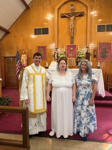 A parishioner making her Baptism and Confirmation by Father Taylor, on April 19 at St Joseph Church, St. Joseph, LA. 