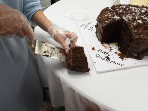 Serving Mr. Duplechin's chocolate cake from Mater Dolorosa, Plaucheville. Desserts with the Seminarians held at Maryhill on Thursday, July 23. 